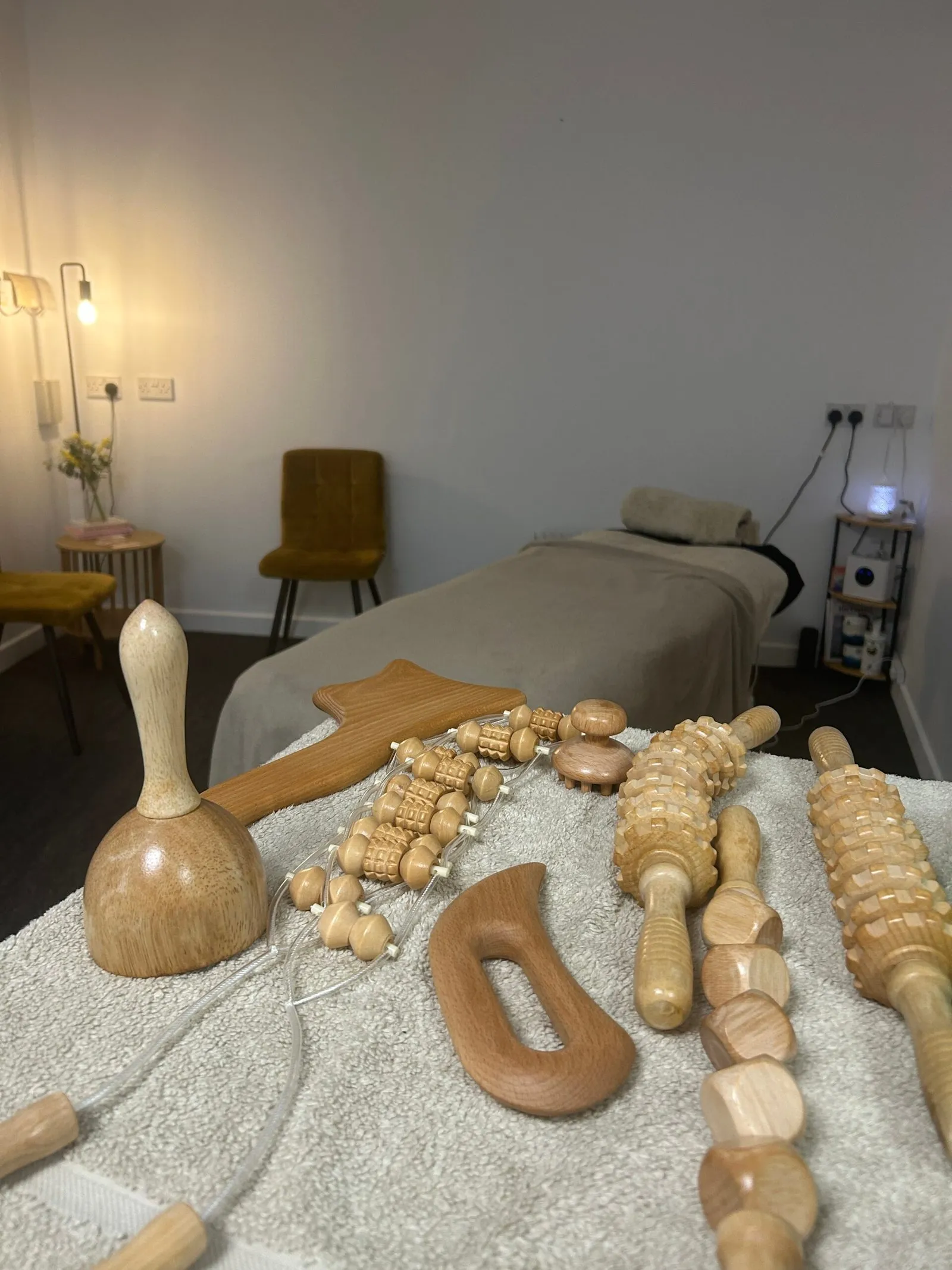 Wooden Maderotherapy tools laid out in the treatment room