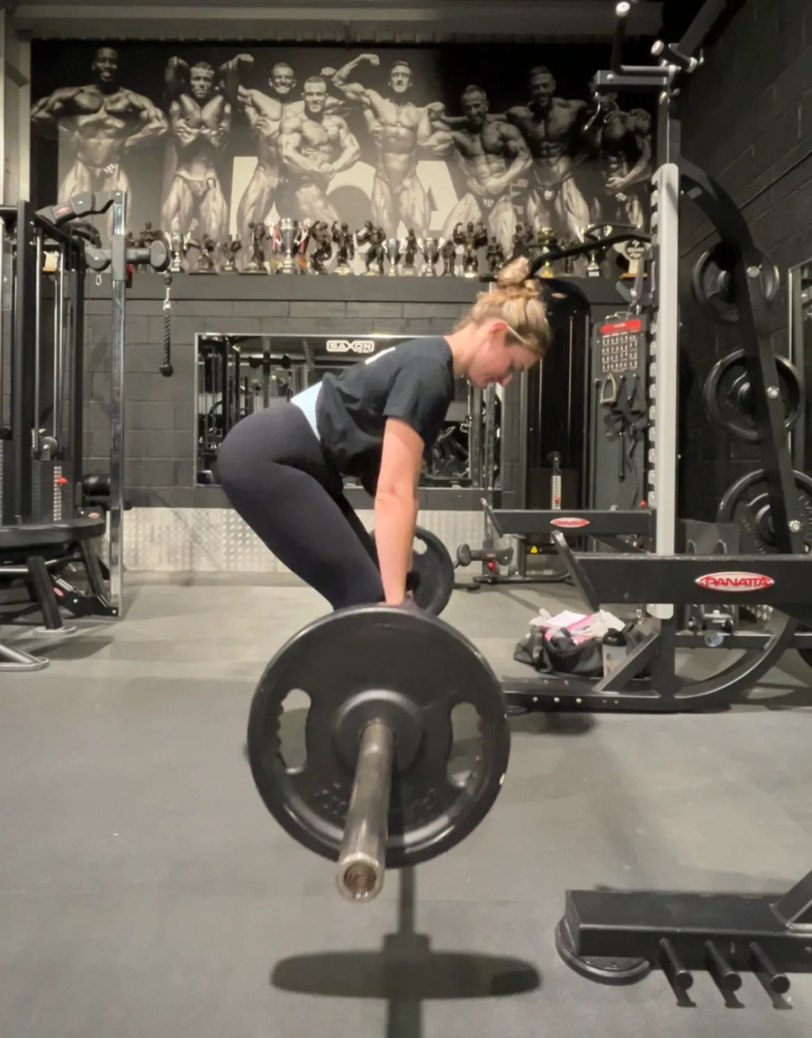 A personal training session in the gym, coaching a deadlift